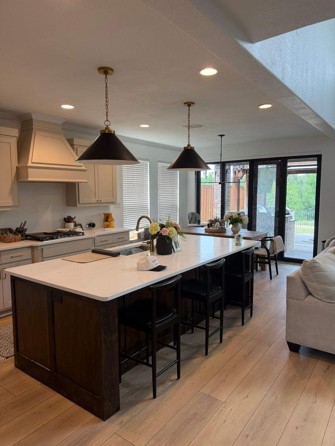 Open-concept kitchen with large island and pendant lighting
